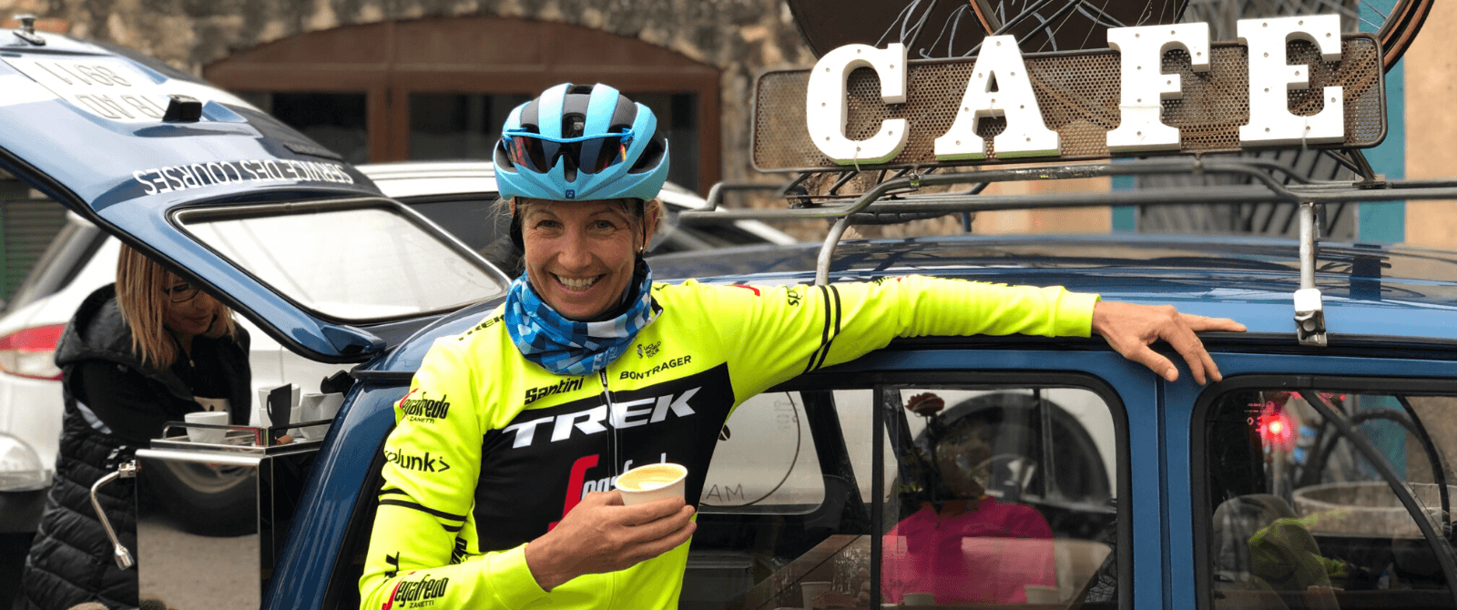 woman smiling while enjoying a hot coffee
