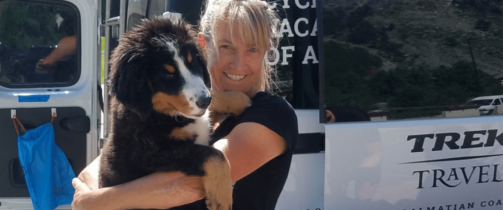 woman smiling with a dog in her arms