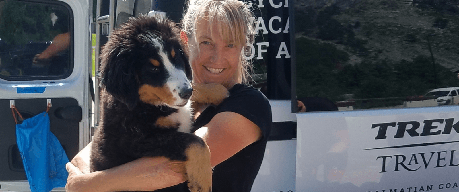woman smiling with a dog in her arms