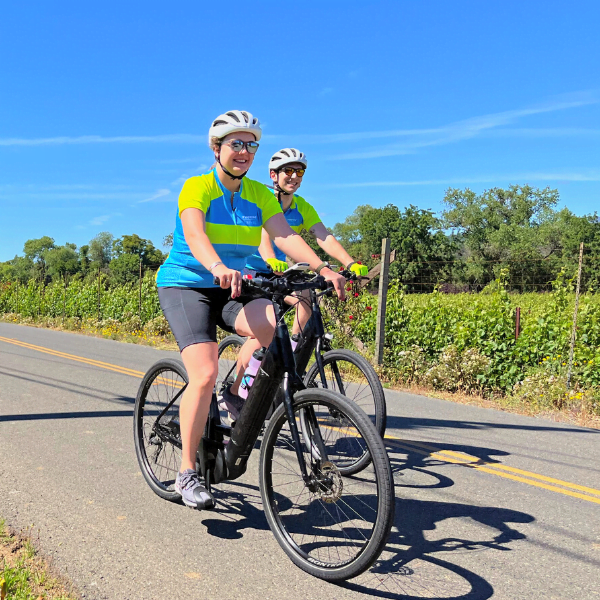 Two people riding bikes on a sunny day in California