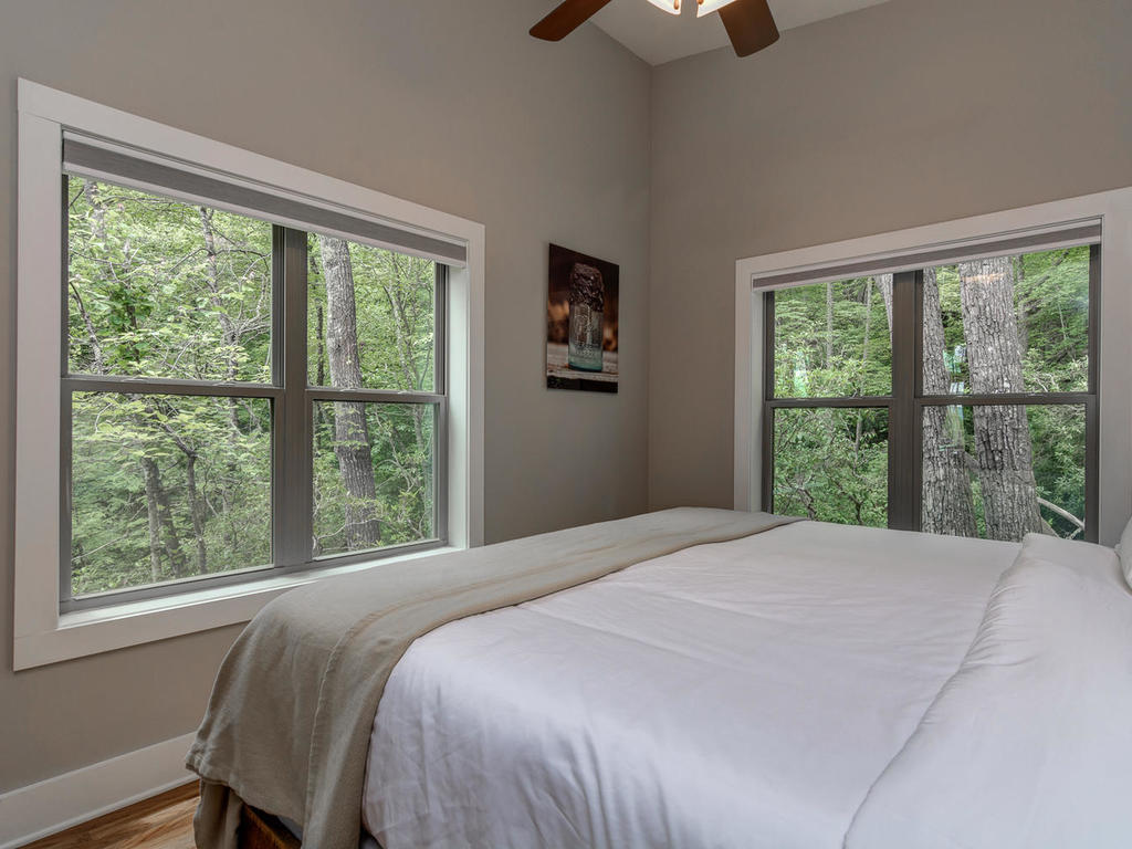 Interior shot of bedroom looking out the window at Pilot Cove cabins