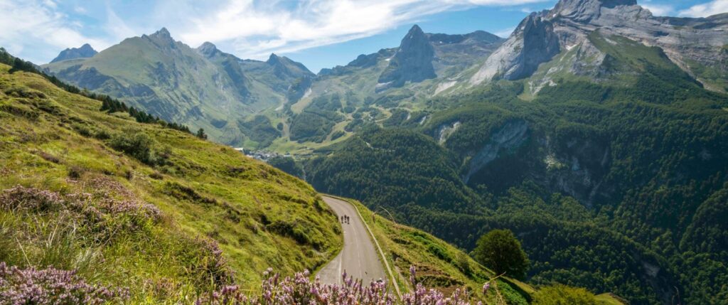 Aerial view of three cyclists and the mountains